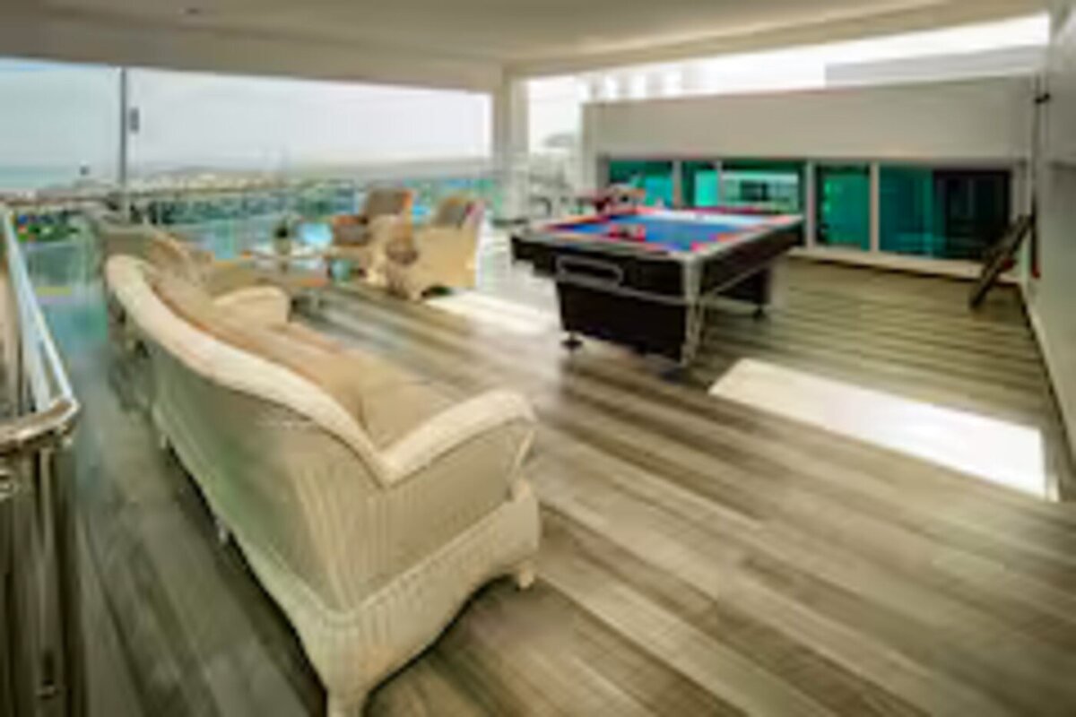 Rooftop lounge with pool table and ocean view