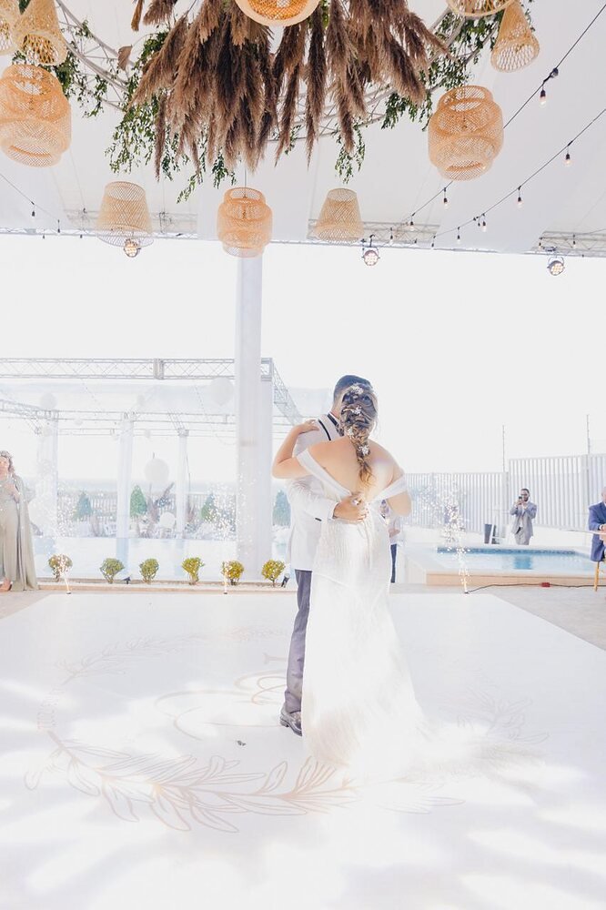 Bride and groom's first dance under string lights at Melody Village